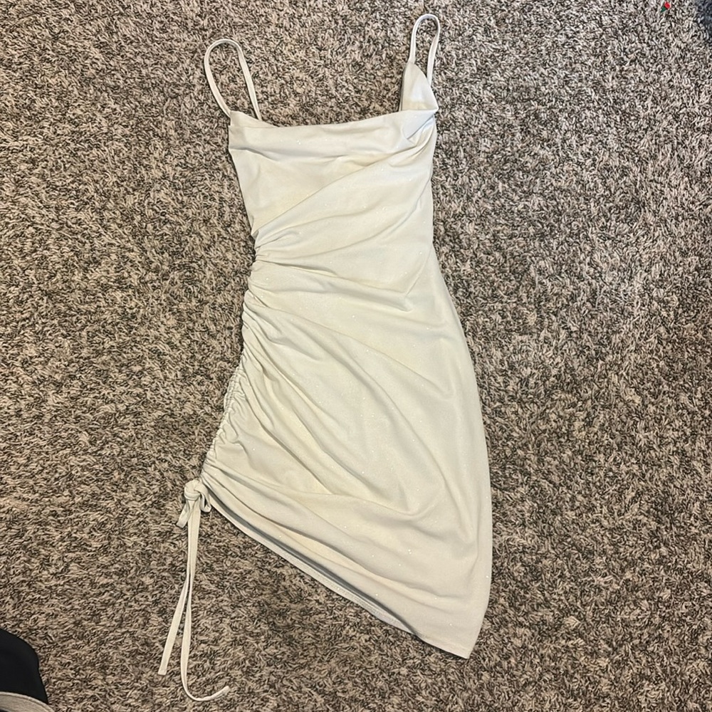 White sparkly short dress with sinch on side and cross straps in back